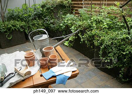 Stock Photo - High angle view of gardening tools on the table. Fotosearch