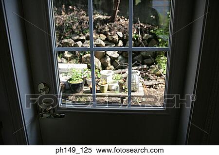 High angle view of potted plants viewed through a door View Large Photo Image Stock Photography - High angle view of potted plants viewed through a door. Fotosearch