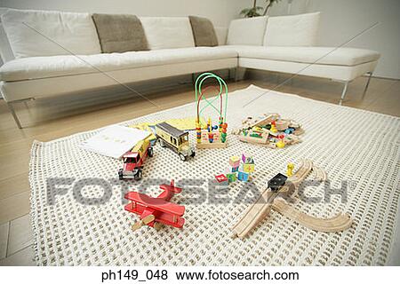 High angle view of toys on a mat in the living room View Large Photo Image Stock Photo - High angle view of toys on a mat in the living room. Fotosearch