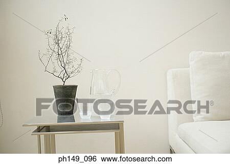 Jug and two glasses of water near a potted plant on the table View Large Photo Image Stock Photograph - Jug and two glasses of water near a potted plant on the table. Fotosearch