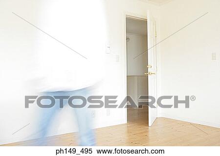 Mid section view of a man walking in a room View Large Photo Image Stock Photography - Mid section view of a man walking in a room. Fotosearch