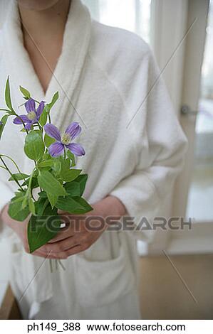 Mid section view of a woman holding flowers View Large Photo Image Stock Photo - Mid section view of a woman holding flowers. Fotosearch