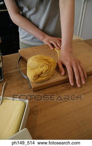 Mid section view of a woman preparing food in the kitchen View Large Photo Image Picture - Mid section view of a woman preparing food in the kitchen. Fotosearch