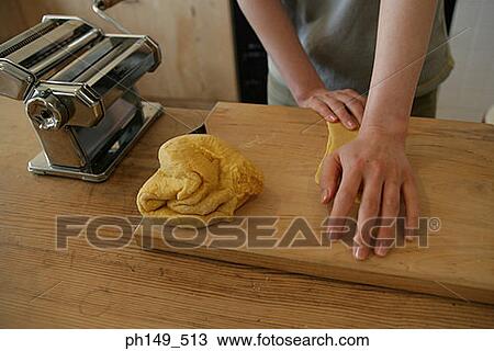 Mid section view of a woman preparing food in the kitchen View Large Photo Image Stock Image - Mid section view of a woman preparing food in the kitchen. Fotosearch