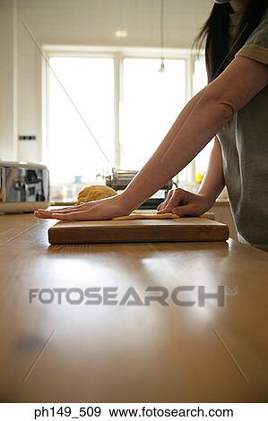 Mid section view of a woman preparing food in the kitchen View Large Photo Image Stock Photo - Mid section view of a woman preparing food in the kitchen. Fotosearch