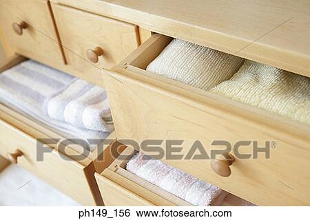 Stock Photograph - Neatly arranged clothing in drawers. Fotosearch