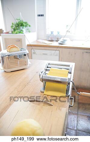 Stock Photo - Pasta maker and a toaster in the kitchen. Fotosearch