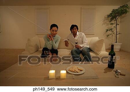 Portrait of a young couple sitting on a couch View Large Photo Image Stock Photo - Portrait of a young couple sitting on a couch. Fotosearch