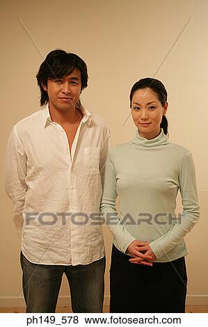 Portrait of a young couple standing View Large Photo Image Stock Photo - Portrait of a young couple standing. Fotosearch