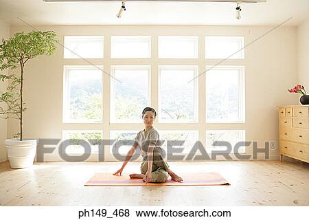 Portrait of a young woman practicing yoga View Large Photo Image Stock Photo - Portrait of a young woman practicing yoga. Fotosearch