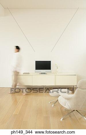 Side profile of a man walking in a room View Large Photo Image Picture - Side profile of a man walking in a room. Fotosearch