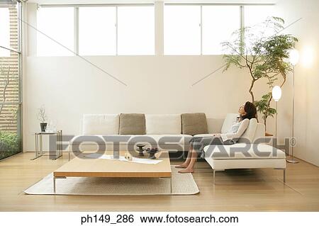 Side profile of a young woman sleeping on a couch View Large Photo Image Stock Photograph - Side profile of a young woman sleeping on a couch. Fotosearch