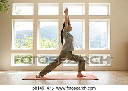 Side profile of a young woman practicing yoga View Large Photo Image Stock Photography - Side profile of a young woman practicing yoga. Fotosearch