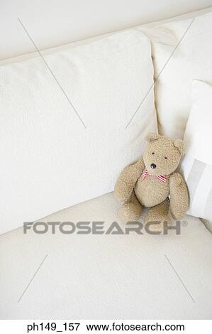 Teddy bear on a couch View Large Photo Image Stock Photo - Teddy bear on a couch. Fotosearch