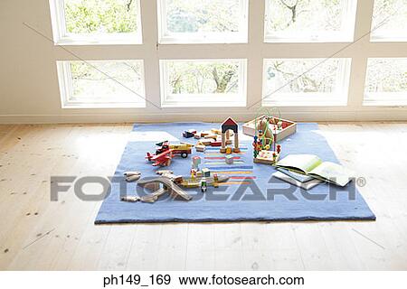 Stock Photo - Toys and building blocks on a carpet. Fotosearch