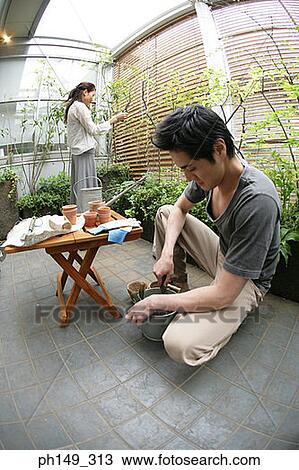 Young couple gardening View Large Photo Image Stock Image - Young couple gardening. Fotosearch