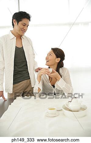 Young couple looking at each other View Large Photo Image Stock Image - Young couple looking at each other. Fotosearch
