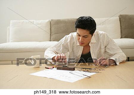 Young man assembling a model of an airship View Large Photo Image Stock Photo - Young man assembling a model of an airship. Fotosearch