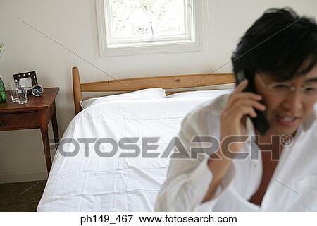 Young man talking on a mobile phone View Large Photo Image Stock Photo - Young man talking on a mobile phone. Fotosearch