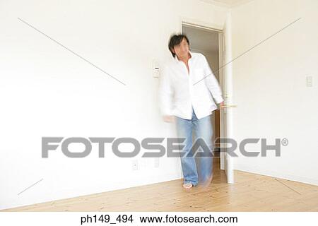 Young man walking into a room View Large Photo Image Picture - Young man walking into a room. Fotosearch
