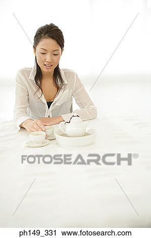 Young woman holding a cup of tea View Large Photo Image Stock Image - Young woman holding a cup of tea. Fotosearch