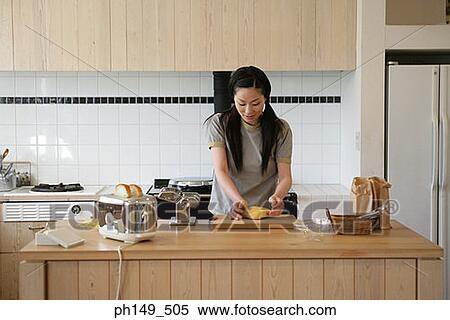 Young woman kneading pasta dough in the kitchen View Large Photo Image Stock Photography - Young woman kneading pasta dough in the kitchen. Fotosearch