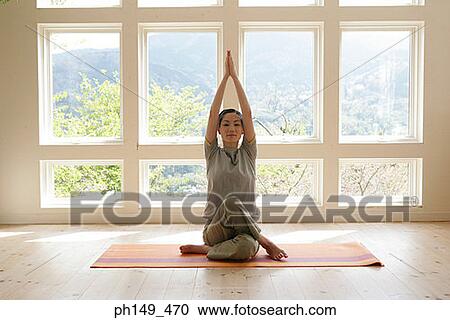 Young woman practicing yoga View Large Photo Image Stock Image - Young woman practicing yoga. Fotosearch