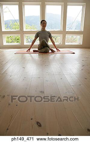 Young woman practicing yoga View Large Photo Image Stock Image - Young woman practicing yoga. Fotosearch