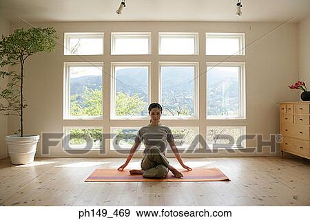 Young woman practicing yoga View Large Photo Image Stock Photo - Young woman practicing yoga. Fotosearch