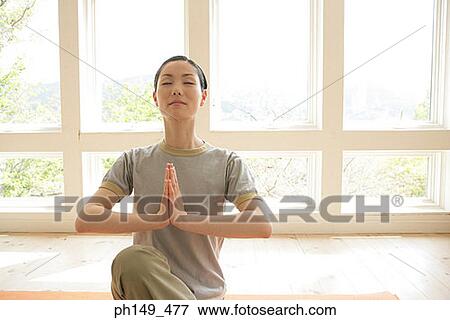 Young woman practicing yoga View Large Photo Image Stock Photo - Young woman practicing yoga. Fotosearch