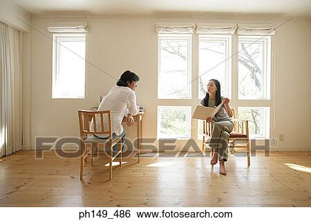 Young woman showing a file to a young man View Large Photo Image Stock Photograph - Young woman showing a file to a young man. Fotosearch