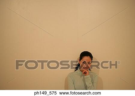 Young woman smiling with her hand on her chin View Large Photo Image Stock Photography - Young woman smiling with her hand on her chin. Fotosearch