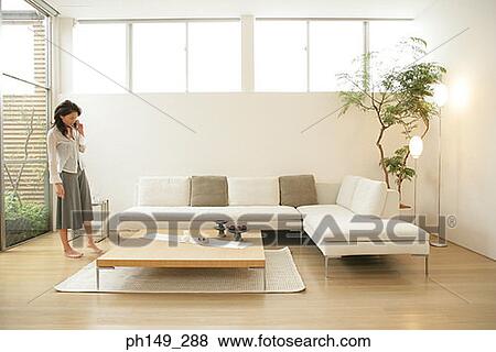 Young woman talking on a mobile phone View Large Photo Image Stock Photo - Young woman talking on a mobile phone. Fotosearch