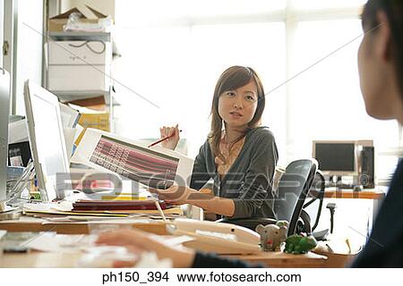 Businesswoman holding a sheet of paper View Large Photo Image Picture - Businesswoman holding a sheet of paper. Fotosearch