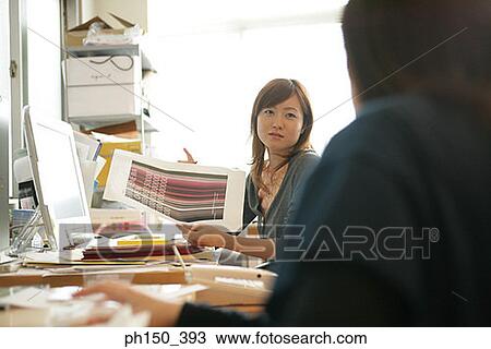 Businesswoman holding a sheet of paper View Large Photo Image Stock Image - Businesswoman holding a sheet of paper. Fotosearch