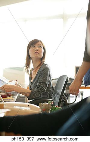 Businesswoman looking at person View Large Photo Image Stock Photo - Businesswoman looking at person. Fotosearch