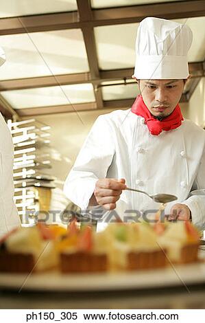 Chef decorating a strawberry tart in a restaurant View Large Photo Image Stock Photography - Chef decorating a strawberry tart in a restaurant. Fotosearch