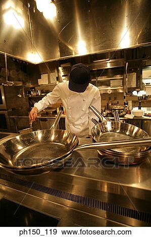 Chef preparing food in the kitchen View Large Photo Image Stock Photo - Chef preparing food in the kitchen. Fotosearch