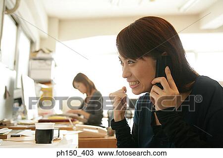 Close-up of a businesswoman talking on a mobile phone View Large Photo Image Stock Image - Close-up of a businesswoman talking on a mobile phone. Fotosearch