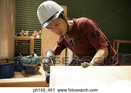 Close-up of a carpenter drilling a hole in wood View Large Photo Image Stock Image - Close-up of a carpenter drilling a hole in wood. Fotosearch
