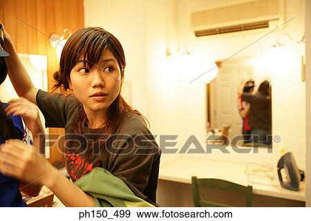 Stock Photo - Close-up of a fashion designer in a dressing room. Fotosearch