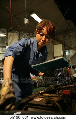 Close-up of a female auto mechanic examining an engine View Large Photo Image Stock Image - Close-up of a female auto mechanic examining an engine. Fotosearch