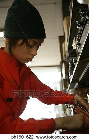 Close-up of a female auto mechanic holding a work tool View Large Photo Image Stock Image - Close-up of a female auto mechanic holding a work tool. Fotosearch