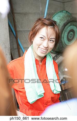 Close-up of a female auto mechanic smiling View Large Photo Image Stock Image - Close-up of a female auto mechanic smiling. Fotosearch