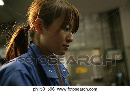 Close-up of a female auto mechanic View Large Photo Image Stock Photograph - Close-up of a female auto mechanic. Fotosearch