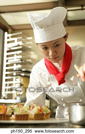 Close-up of a female chef preparing a strawberry tart in a restaurant View Large Photo Image Stock Photography - Close-up of a female chef preparing a strawberry tart in a restaurant. Fotosearch