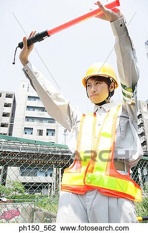 Close-up of a female traffic cop holding up a nightstick View Large Photo Image Stock Image - Close-up of a female traffic cop holding up a nightstick. Fotosearch