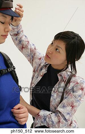 Stock Image - Close-up of a hairdresser assisting a female fashion model. Fotosearch