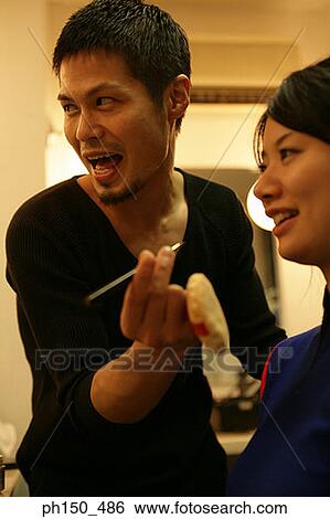 Close-up of a makeup artist holding a lip liner with a female fashion model smiling View Large Photo Image Stock Photograph - Close-up of a makeup artist holding a lip liner with a female fashion model smiling. Fotosearch