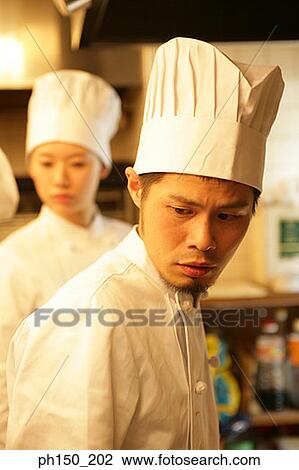 Close-up of a male chef and a female chef in the kitchen View Large Photo Image Stock Image - Close-up of a male chef and a female chef in the kitchen. Fotosearch